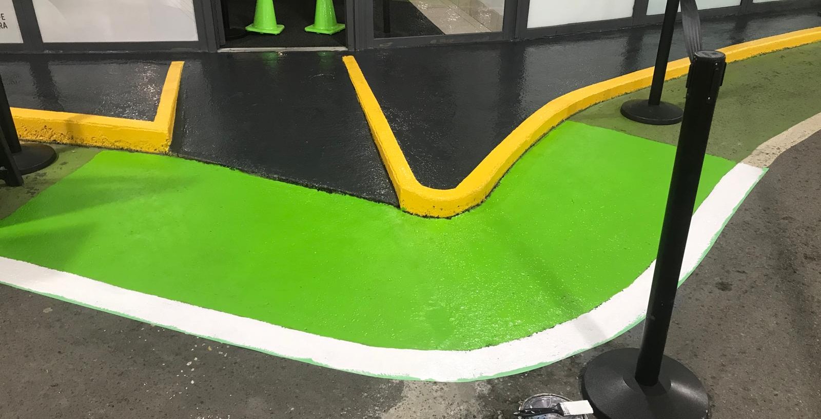 Painted walls and ceiling details along a parking garage ramp