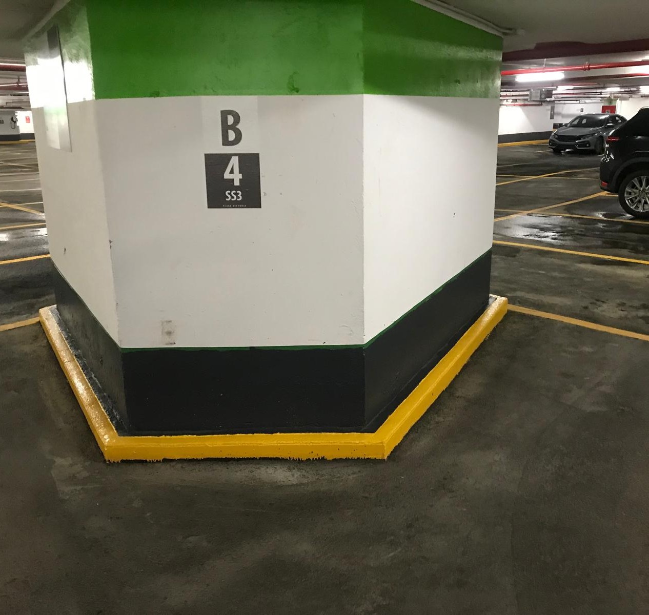 Repainted parking column with a contrasting yellow curb
